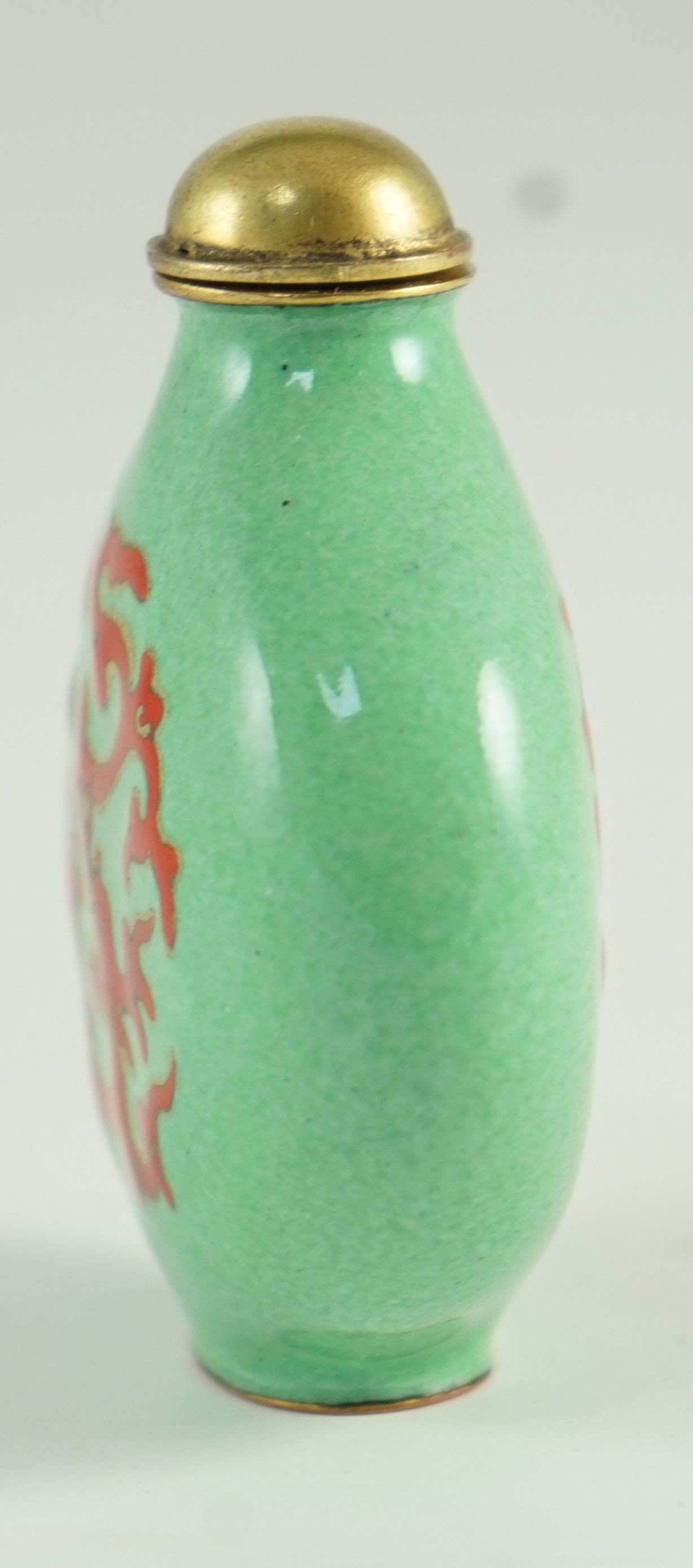 A Chinese enamel on copper green ground snuff bottle, 19th/20th century, 6.2 cm high including stopper